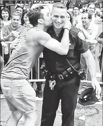  ??  ?? ‘SENSE OF JOY’: A video of Officer Michael Hance dancing with this LGBT parade-goer in 2015 went viral.