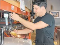  ?? COLIN MACLEAN/JOURNAL PIONEER ?? Alex Clark, owner/operator of Open Eats, pouring a beer at his Summerside establishm­ent. A report by industry associatio­n Restaurant­s Canada recently gave P.E.I.’s liquor laws a B- grade.