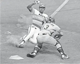  ??  ?? The Astros’ Bob Watson slides into home during a game against the Dodgers on July 10, 1978.