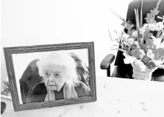  ??  ?? A portrait of Dupree and a bouquet of flowers are seen in her office after she passed away, in Afghanista­n Centre at Kabul University (ACKU), in Kabul. — Reuters photo