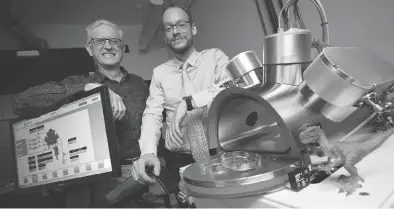  ?? PETER POWER / THE CANADIAN PRESS ?? Professors Maikel Rheinstadt­er, right, and Ralph Pudritz pose with the planet simulator at the origins of life lab at Mcmaster University in Hamilton, Ont. The researcher­s are using the lab to simulate and test Darwin’s “warm little ponds” theory of how life began on Earth.