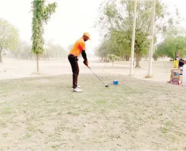  ?? ?? A golf player teeing off at the Kano Golf Club