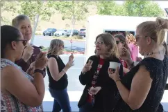  ?? Ryan Mancini/The Signal (See additional photos at signalscv.com) ?? Castaic Union School District teachers and staff enjoy an ice cream treat from Sweet Beams Ice Cream in the shade on Wednesday.