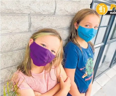  ?? ?? Aaliyah, 7, and Hayley, 10, Ryan are all smiles under their masks when wearing their personalis­ed ones made by Stratford based online business Dubzseven gift n treats.