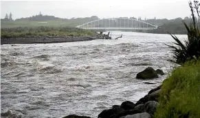  ??  ?? The Te Rewa Rewa Bridge over troubled waters of the Waiwhakaih­o river.