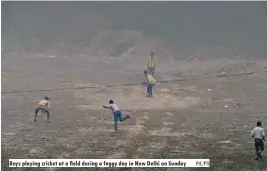  ?? PIC/PTI ?? Boys playing cricket at a field during a foggy day in New Delhi on Sunday