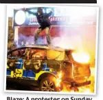  ??  ?? Blaze: A protester on Sunday