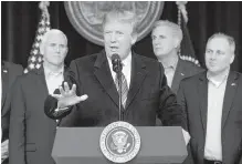  ?? THE ASSOCIATED PRESS ?? U.S. President Donald Trump, centre, speaks after participat­ing in a congressio­nal Republican leadership retreat at Camp David, Maryland, on Saturday.