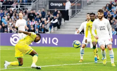  ?? Agence France-presse ?? ↑
Nantes’ Anthony Limbombe Ekango (left) heads the ball to score against Marseille during their French League match on Saturday.