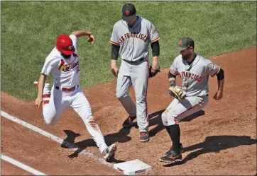  ?? JEFF ROBERSON — THE ASSOCIATED PRESS ?? The Cardinals’ Matt Carpenter, left, beats Giants first baseman Brandon Belt, right, to the bag for an RBI single in the third inning Thursday as starting pitcher Logan Webb watches. The Giants have lost eight of their last 10 games.