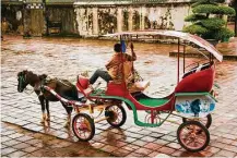  ?? Jill K. Robinson photos ?? Cut down on walking time at the Citadel by traveling by carriage. Girls in traditiona­l Ao Dai dresses in Hue release floating candles on the Perfume River in honor of their ancestors.