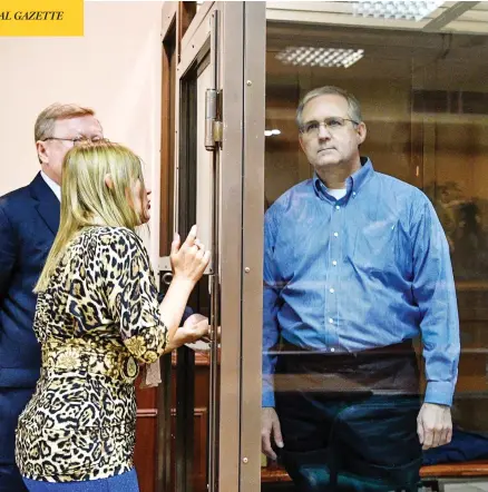  ?? MLADEN ANTONOV / AFP / GETTY IMAGES ?? Paul Whelan, a Canadian former U.S. Marine who is accused of espionage, listens to his lawyers from inside a defendants’ cage during his first court hearing in Moscow on Tuesday. He was arrested shortly after receiving a USB stick that he thought contained photos of a church.