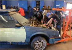  ?? PHOTOS BY DAVE JOHNSON/WELLAND TRIBUNE ?? A group of students work on a car engine at Niagara District Catholic School Board’s Launch Centre Thursday. There was an open house at the centre, which is housed in the back part of the former Target store at Seaway Mall.