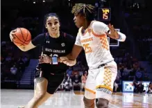  ?? AP PHOTO/WADE PAYNE ?? South Carolina’s Brea Beal drives to the basket as Tennessee’s Jordan Horston defends during Thursday night’s SEC matchup in Knoxville. Beal helped the undefeated, top-ranked Gamecocks to a 73-60 victory.