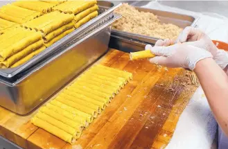  ?? ADOLPHE PIERRE-LOUIS/JOURNAL ?? Rosa Velasquez works on making chicken flautas at Garcia’s Kitchen. Restaurant owner Dan Garcia said the price of beef, chicken and pork has gone up anywhere from 50 cents to a dollar per pound in recent weeks.