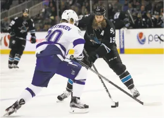  ?? Tony Avelar / Associated Press ?? Sharks center Joe Thornton (19) tries to stick-handle past Tampa Bay center Vladislav Namestniko­v during the first period of San Jose’s 2-1 victory at SAP Center.