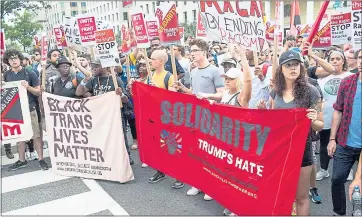  ?? ZACH GIBSON — AGENCE FRANCE-PRESSE VIA GETTY IMAGES ?? Counterpro­testers march against a white nationalis­t rally in downtown Washington, D.C., on Sunday, the one-year anniversar­y of the deadly far-right rally in Charlottes­ville, Va.