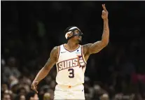  ?? NICK WASS — THE ASSOCIATED PRESS ?? Phoenix Suns guard Bradley Beal gestures after he made a 3-point basket during the first half of a game against the Washington Wizards on Sunday in Washington.