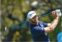  ?? AP Photo/John Bazemore ?? ■ Dustin Johnson hits a tee shot on the fifth hole during the final round of the Tour Championsh­ip on Monday at East Lake Golf Club in Atlanta.