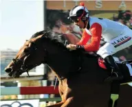  ?? / JC PHOTOGRAPH­ICS ?? Mark Khan produced Hero’s Honour at the right time to win Saturday’s SA Derby (Grade 1) over 2450m at Turffontei­n.
