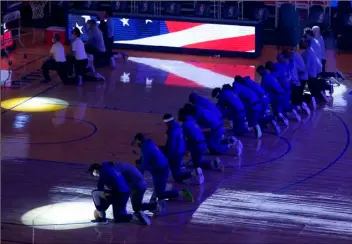  ?? AP Photo/Jeff Chiu ?? Golden State Warriors players and coaches kneel during the national anthem before an NBA basketball game against the Los Angeles Clippers in San Francisco, on Wednesday.