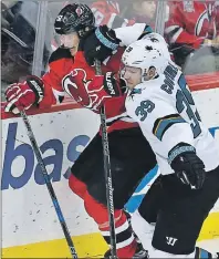  ?? AP PHOTO ?? San Jose Sharks centre Logan Couture (right) hits New Jersey Devils centre Sergey Kalinin during NHL action Sunday in Newark, N.J.