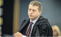  ??  ?? Ian Brookie, counsel for the defendant, addresses the High Court at Auckland yesterday. Crown prosecutor­s Brian Dickey and Robin McCoubrey confer in court yesterday.