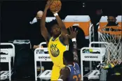  ?? RICK SCUTERI — THE ASSOCIATED PRESS, FILE ?? Warriors center James Wiseman shoots over Suns center Deandre Ayton during the first half on March 4 in Phoenix.
Kerr