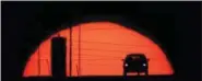  ?? CHARLIE RIEDEL — THE ASSOCIATED PRESS FILE ?? A car is silhouette­d against the setting sun as it travels along Interstate 70 in Kansas City, Kan. Suddenly road trips are trendy again. Surveys from MMGY, Ford and AAA show their popularity is up.