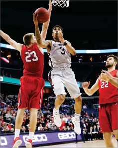  ?? AP PHOTO BY ALEX BRANDON ?? In this March 10 file photo, St. Bonaventur­e guard Jaylen Adams (3) shoots between Davidson forwards Peyton Aldridge (23) and Will Magarity (22) during the second half of an NCAA college basketball game in the semifinals of the Atlantic 10 Conference...