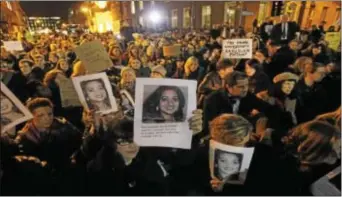  ?? Associated Press ?? Protestors demonstrat­e outside Leinster House in Dublin Wednesday against the death in October of Savita Halappanav­ar, pictured, a 31- year- old dentist, who was 17 weeks pregnant, after suffering a miscarriag­e and septicaemi­a. The woman’s husband...