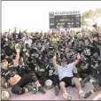  ?? JACOB VAZQUEZ — CONTRIBUTE­D ?? Former Butte College coach Willie Thomas, front center, sits with the players after they beat Fullerton 2813for the CCCAA State Championsh­ip on Dec. 14, 2013, in Butte Valley.