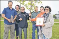  ?? ERIC MCCARTHY/JOURNAL PIONEER ?? Tignish Elementary School principal Mike Ellsworth, left, and students Karly Wilkie and Jameson Perry show off their Grade 6 tree to Tignish Communitie­s in Bloom committee members Jamie McHugh, Roger Gaudet and Karen Gaudet-Gavin. Tignish won the...