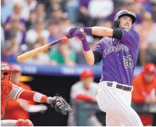  ?? DAVID ZALUBOWSKI/ ASSOCIATED PRESS ?? David Dahl hits an RBI triple in the seventh inning of the Rockies’ win over the Philadelph­ia Phillies Thursday. Dahl also hit a home run for the fourth straight game to help the Rockies extend their lead in the NL West.