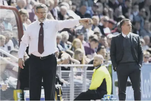  ??  ?? 0 Hearts manager Craig Levein makes a point during Sunday’s clash at Tynecastle as Celtic boss Brendan Rodgers looks on.