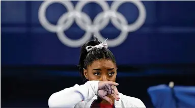  ?? ASHLEY LANDIS/ASSOCIATED PRESS 2021 ?? When seven-time Olympic medalist Simone Biles stepped onto the floor in July for the women’s team final in Tokyo, she was not fine. Biles was suffering from “the twisties,” and she walked off the floor.