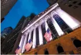  ?? ASSOCIATED PRESS FILE PHOTO ?? American flags fly in front of the New York Stock Exchange. U.S. stocks sank sharply on Thursday after President Donald Trump promised stiff tariffs on imported steel and aluminum.