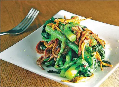  ?? PROVIDED TO CHINA DAILY ?? Stir-fried mustard greens with dried daylilies, or golden needles.
