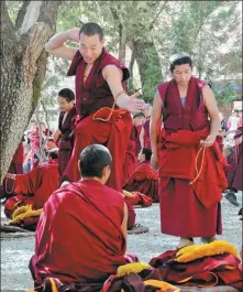  ??  ?? Monks at Sera Monastery, Lhasa, routinely debate Buddhism in the Tibetan language.