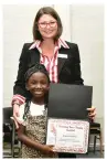  ?? ?? Pine Bluff School District Superinten­dent Jennifer Barbaree presents a “Showing Your Stripes” award to Cortlynn Reed.