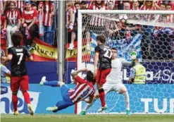  ??  ?? MADRID: Atletico de Madrid’s forward Fernando Torres (L) scores his second goal during the Spanish league football match Club Atletico de Madrid vs Athletic Club Bilbao at the Vicente Calderon stadium. —AFP