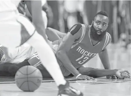  ?? James Nielsen / Houston Chronicle ?? James Harden, losing control during the first quarter, battled ball security issues during Game 5 on Wednesday night. The Rockets guard committed 13 turnovers to set a record for a playoff game.