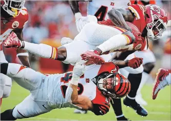  ?? DAVID EULITT GETTY IMAGES ?? Tremon Smith of Kansas is tackled by Clayton Fejedelem of the Bengals during preseason action Saturday. Kansas QB Patrick Mahomes made a big splash last year and appears to be ready to carry on winning.
