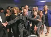  ?? Dan Haar / Hearst Connecticu­t Media ?? Shawn Wooden, center, hams it up with friends, including U.S. House Minority Leader Hakeem Jeffries, D-N.Y., behind Wooden, at a gala in Wooden’s honor Friday at Dunkin’ Donuts Park Hartford.