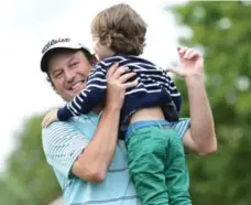  ?? PAUL CHIASSON/THE CANADIAN PRESS ?? South Africa’s Tim Clark celebrates with 3-year-old son Jack after winning the Canadian Open — and over $1 million in prize money — on Sunday.