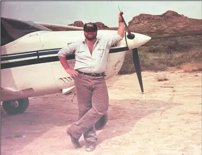  ?? Photo courtesy Kevin Ahl ?? YOUNG PILOT (right)— Kevin Ahl poses for a photo at Serpentine Hot Springs during the first year he joined Bering Air, in 1985.