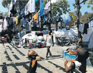  ?? ODELYN JOSEPH/FOR THE ASSOCIATED PRESS ?? Children play in the courtyard of a shelter for families displaced by gang violence last week in Port-au-Prince, Haiti. Many hospitals are now among the casualties of the country’s gang violence.