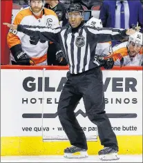  ?? CP PHOTO ?? Linesman Shandor Alphonso signals a clean transition across the blue line during the third period of an NHL game between the Arizona Coyotes and the Philadelph­ia Flyers Saturday, Feb. 10, 2018, in Glendale, Ariz.