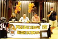  ?? MARK HUMPHREY ENTERPRISE-LEADER ?? Prairie Grove senior Dawson West signs a national letter of intent to play college football as a defensive end for Hendrix College May 11. He was accompanie­d by his parents, who are both Prairie Grove alumni, mother Christie Moore (right) and father...