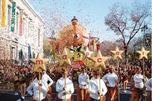  ??  ?? ■ LEFT: Performers walk in front of Macy’s Tom Turkey float as they kick off the 92nd annual Macy’s Thanksgivi­ng Day Parade on Thursday in New York.